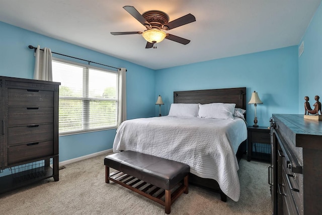 carpeted bedroom featuring baseboards, ceiling fan, and visible vents