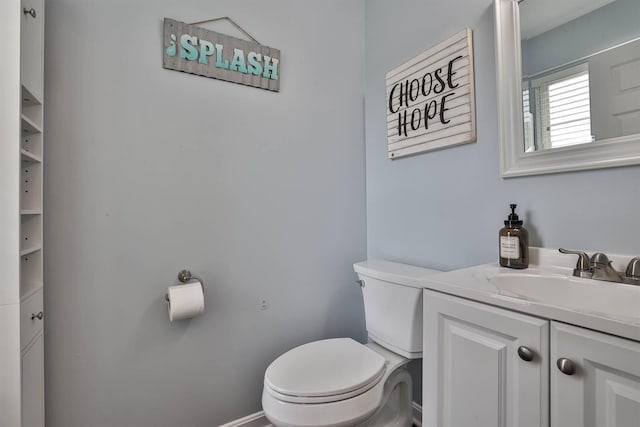 half bathroom with vanity and toilet