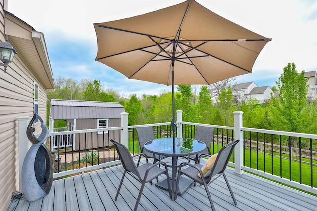 deck featuring an outdoor structure and outdoor dining area