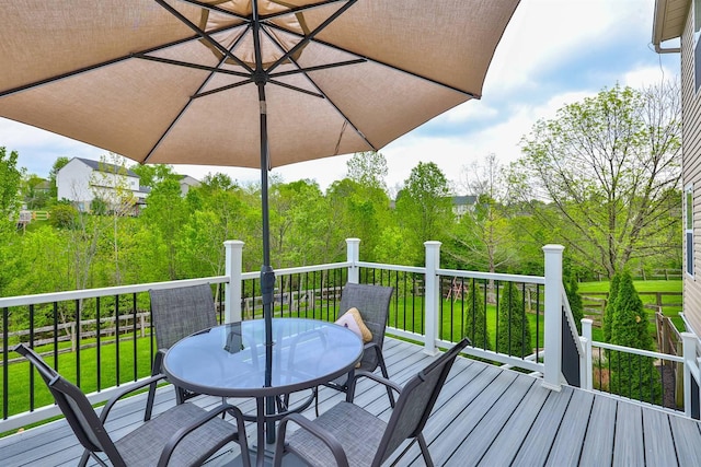 wooden terrace with outdoor dining space