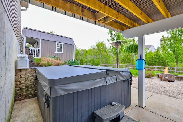 view of patio / terrace featuring a hot tub and a fenced backyard