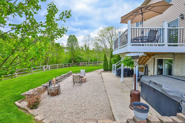view of patio featuring a fenced backyard, a hot tub, and a wooden deck