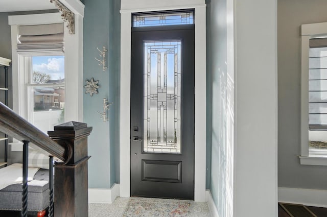entryway featuring a healthy amount of sunlight and baseboards