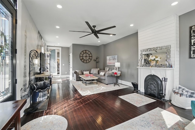 living room with a ceiling fan, baseboards, recessed lighting, and wood-type flooring