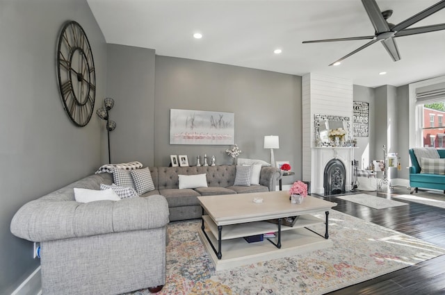 living area with recessed lighting, wood finished floors, baseboards, and ceiling fan