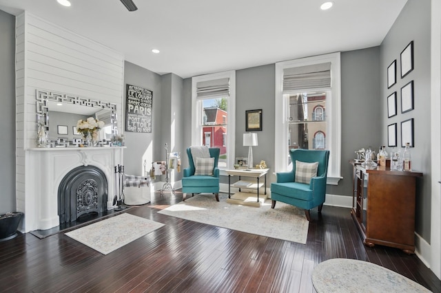 living area with hardwood / wood-style floors, baseboards, a fireplace, and recessed lighting