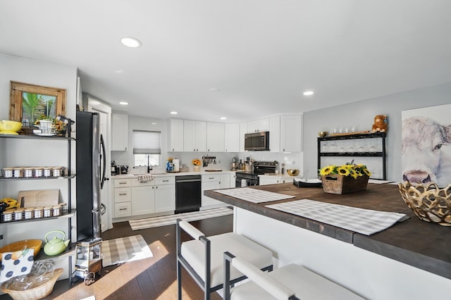 kitchen featuring appliances with stainless steel finishes, white cabinetry, and recessed lighting