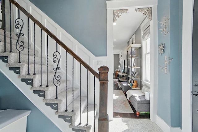 stairs featuring recessed lighting and wood finished floors