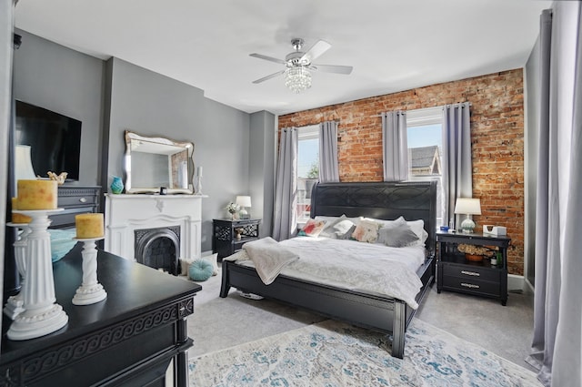 bedroom with light carpet, a ceiling fan, baseboards, and brick wall