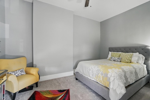 carpeted bedroom featuring a ceiling fan and baseboards