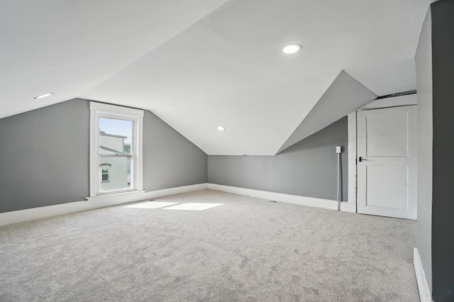 additional living space featuring recessed lighting, vaulted ceiling, carpet flooring, and baseboards