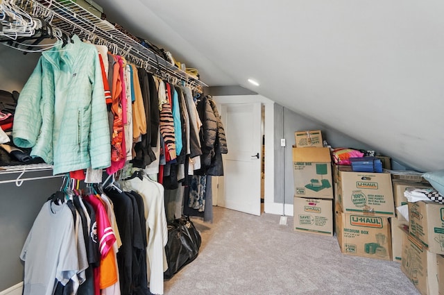 spacious closet with vaulted ceiling and carpet flooring