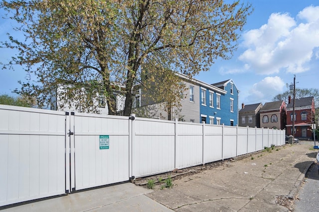 view of side of property featuring a gate and fence