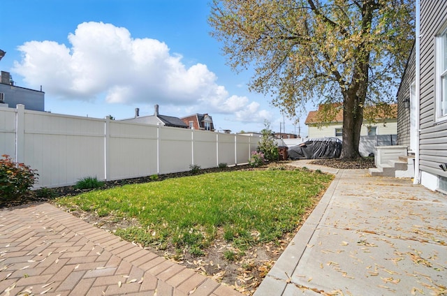 view of yard with a patio and a fenced backyard