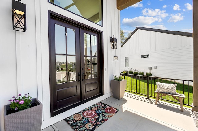 property entrance with a yard and french doors