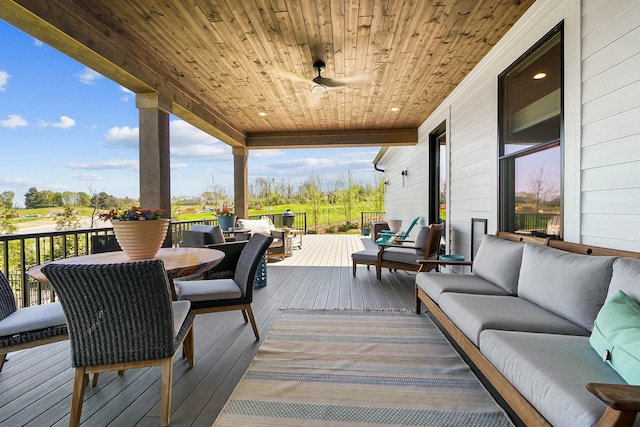 deck with ceiling fan and an outdoor living space