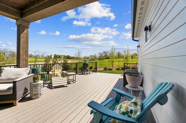 wooden terrace with an outdoor hangout area