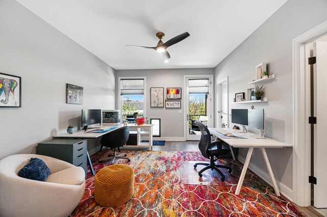 office space featuring wood finished floors, a ceiling fan, and baseboards
