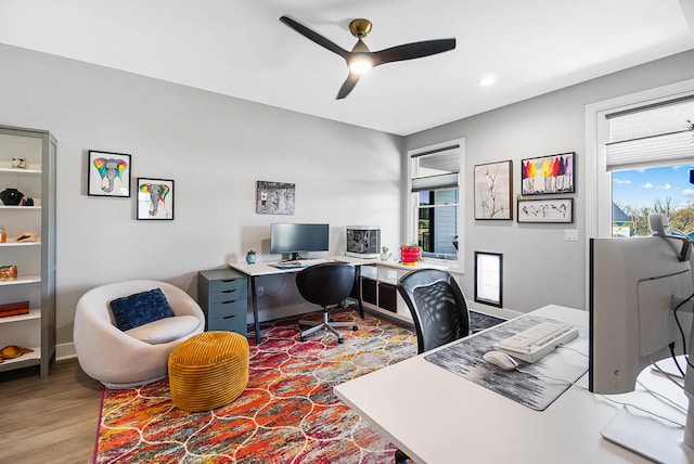 office space with recessed lighting, plenty of natural light, a ceiling fan, and wood finished floors