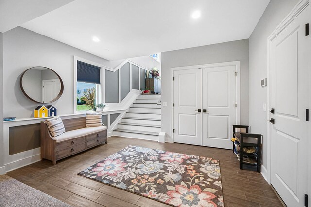 interior space featuring recessed lighting, wood finished floors, and stairs