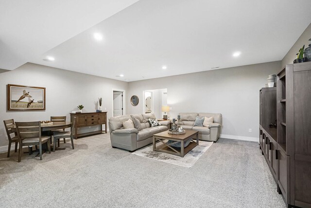living area featuring light carpet, baseboards, and recessed lighting