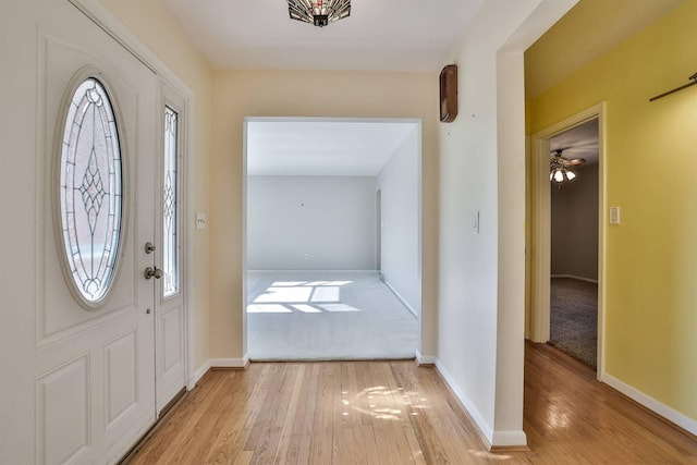 entrance foyer with light wood-style floors and baseboards