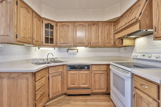 kitchen featuring light countertops, a sink, paneled dishwasher, and white electric range