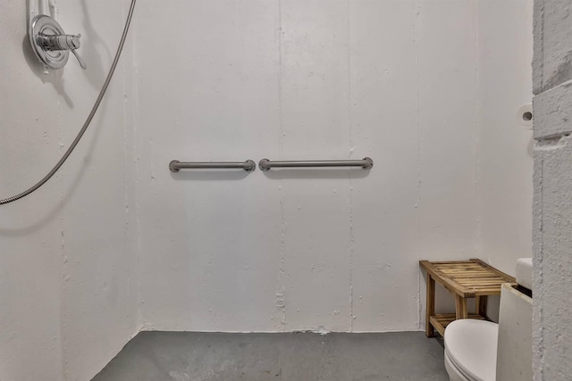 interior space with toilet and concrete flooring