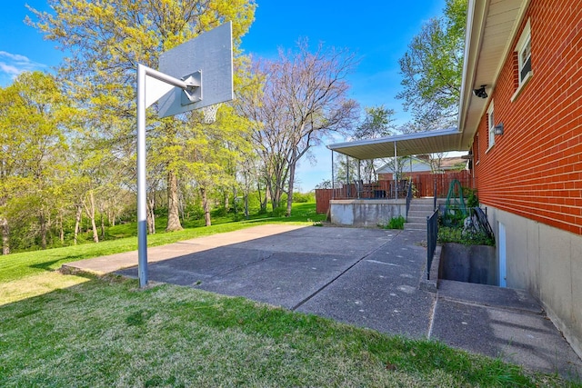 view of sport court with a yard