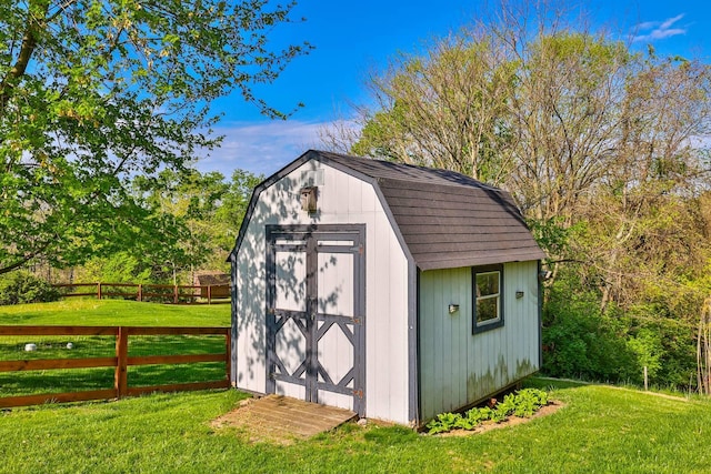 view of shed featuring fence