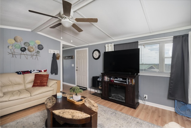 living room featuring baseboards, wood finished floors, ceiling fan, and lofted ceiling with beams