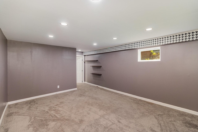 basement featuring recessed lighting, baseboards, and carpet