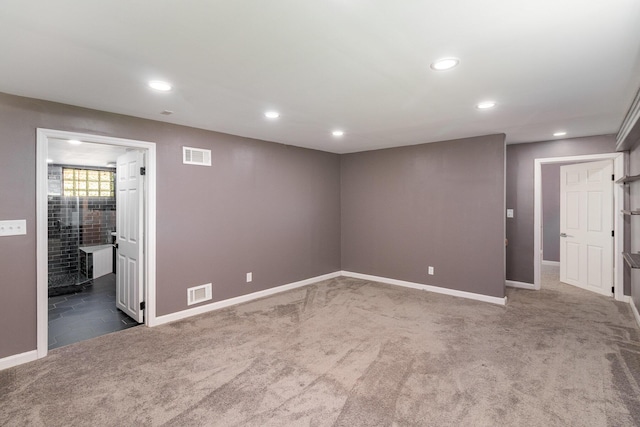 below grade area featuring visible vents, recessed lighting, and carpet floors