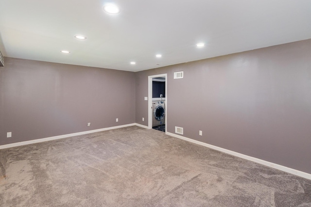 unfurnished room featuring carpet floors, recessed lighting, washer / dryer, and visible vents