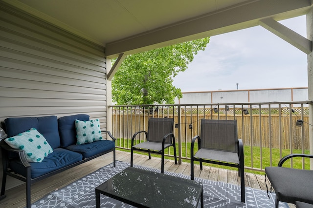 wooden terrace featuring an outdoor living space