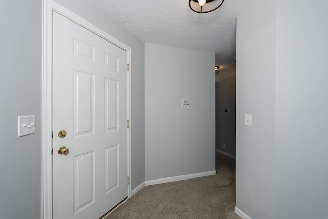 corridor with carpet floors and baseboards
