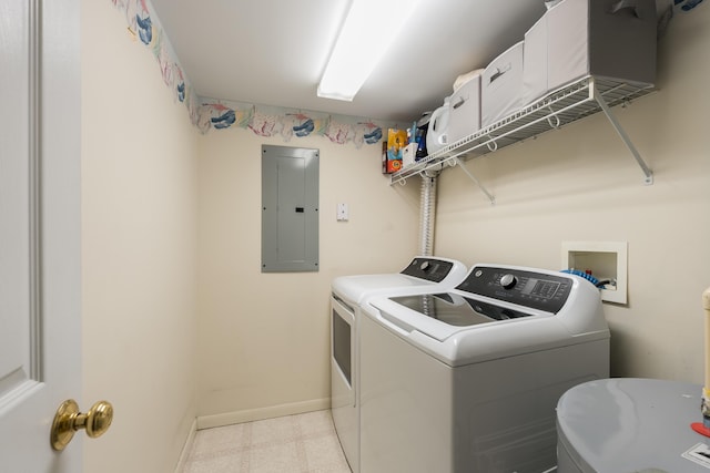 laundry room featuring electric panel, independent washer and dryer, baseboards, and light floors