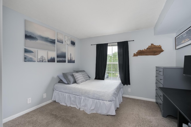 bedroom with carpet and baseboards