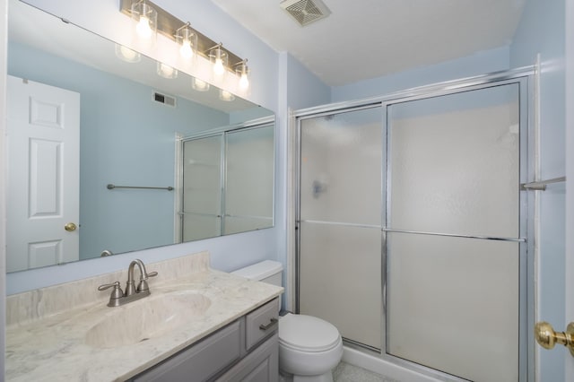 bathroom featuring toilet, an enclosed shower, and vanity
