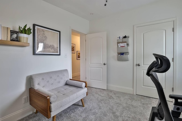 sitting room with baseboards and carpet floors