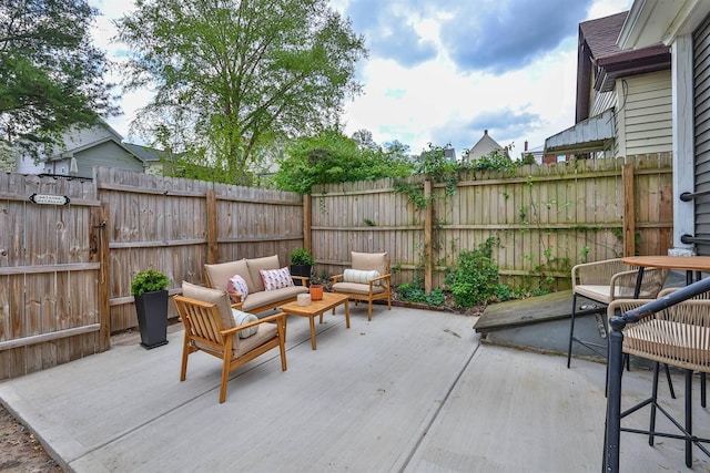 view of patio with an outdoor hangout area and a fenced backyard