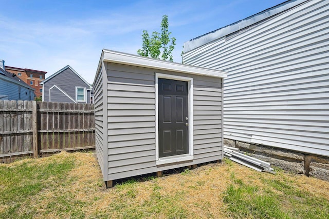 view of shed featuring fence