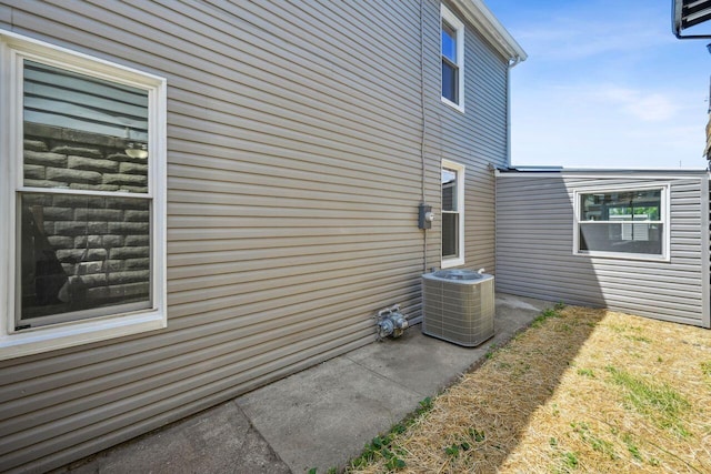 view of side of home with central AC unit