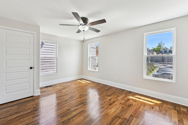 unfurnished bedroom featuring baseboards, a ceiling fan, wood finished floors, and visible vents