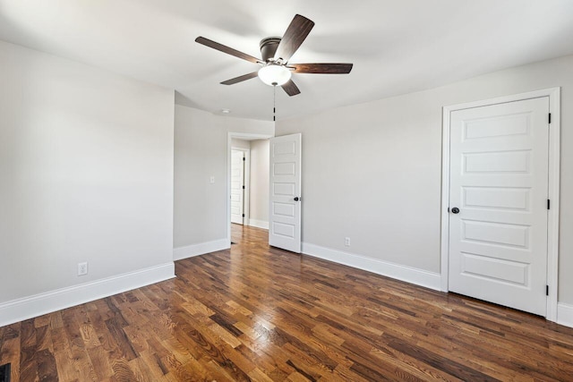 unfurnished bedroom with baseboards, dark wood-style floors, and ceiling fan