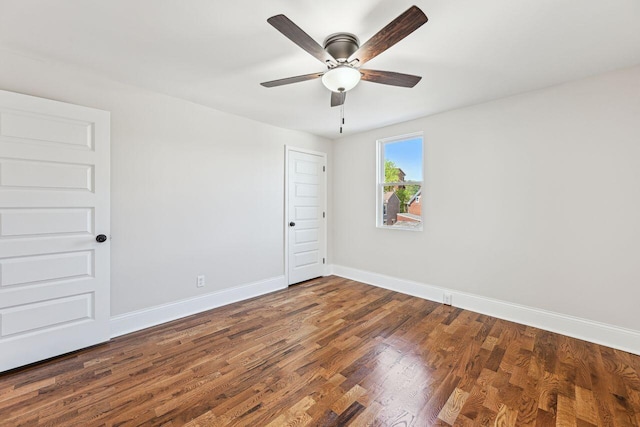 empty room featuring baseboards, ceiling fan, and wood finished floors