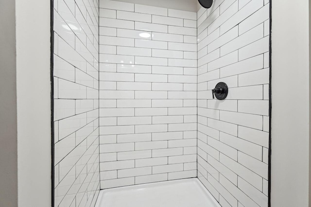full bathroom with a tile shower