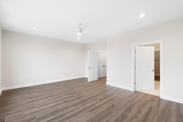spare room featuring wood finished floors, ceiling fan, recessed lighting, and baseboards