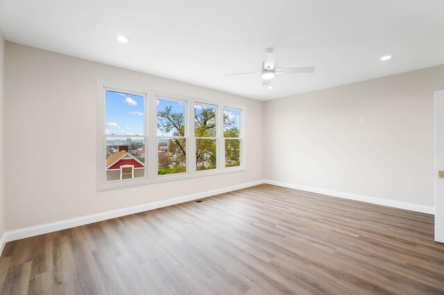 unfurnished room featuring wood finished floors, ceiling fan, recessed lighting, and baseboards