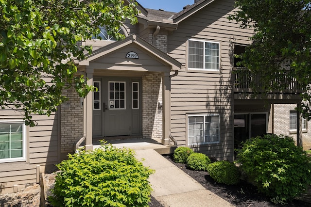 doorway to property with brick siding